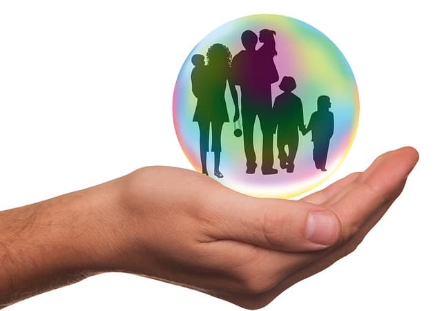 hand holding crystal ball with people